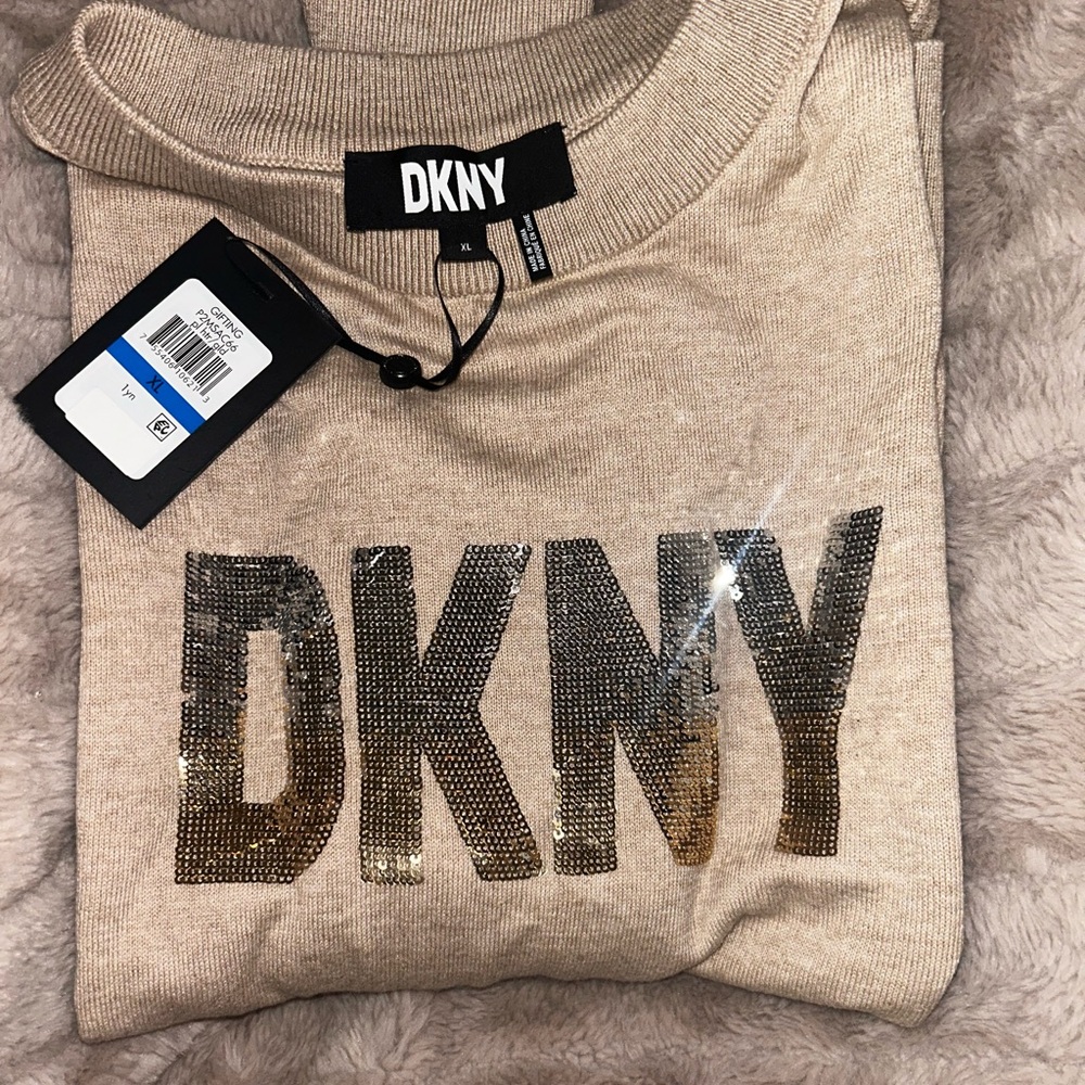 Brand new DKNY sweater with sequins logo.